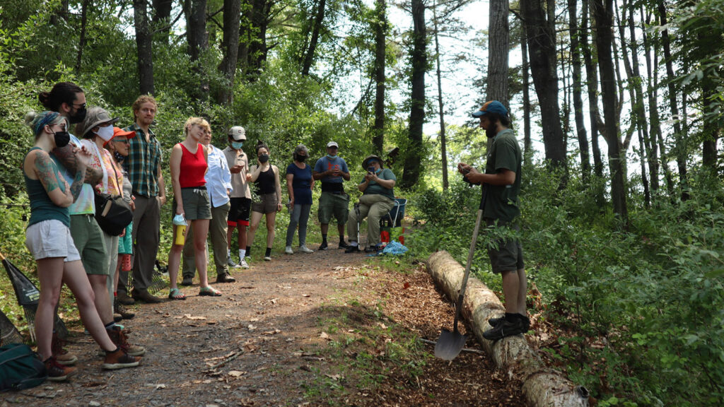 Luke Sarrantonio takes to students along a woody trail
